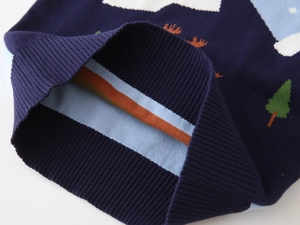 Close-up of boys knit sweater hem with ribbed cuffs and double-sided tree pattern