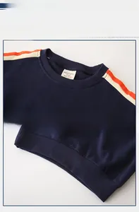 Detail of navy boy's sweatshirt showing striped shoulder design and ribbed crew neck fabric