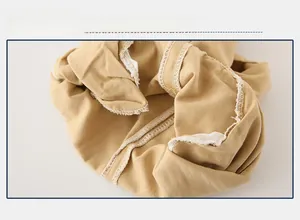 Detailed macro view showing the internal stitching and seam finish of khaki cotton shorts