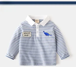 Detail of boys striped polo shirt with Strong Baby dinosaur embroidery and white collar