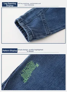 Detail of elastic cuffs and green Red Rabbit letter embroidery on indigo denim pants