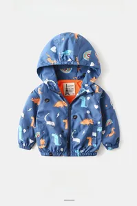 Detail of blue hooded jacket with dinosaur print and orange breathable mesh lining