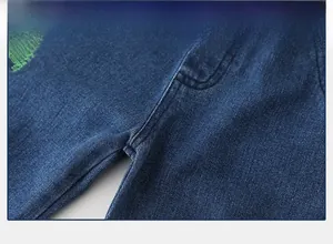 Detail shot of stitched crotch craftsmanship and embroidery on boys denim jeans