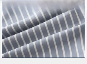Close-up of soft blue and white striped cotton fabric for kids long sleeve polo shirt