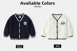 Detail of V-neck kids cardigans in navy and cream with striped trims and car embroidery