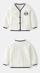Detail of a knit cardigan for boys with car embroidery and navy contrast stripes