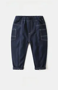 Detailed view of boys navy cotton twill casual pants with white contrast stitching and elastic waist