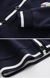 Close-up of boys' navy blue knit cardigan with striped cuffs and cartoon patch