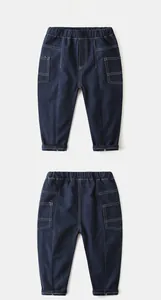 Detail view of boys navy blue cargo pants with white contrast stitching and elastic waist