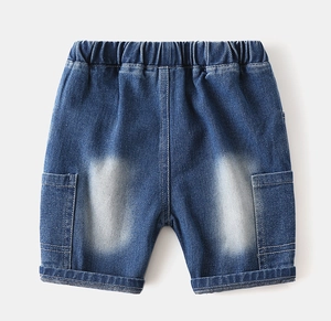 Detail of boys denim shorts with elastic waist and cargo pockets in blue wash