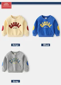 Three kids' round neck sweatshirts in beige, blue, and gray with sleeve patch details