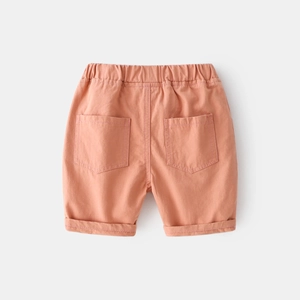 Detail of coral orange boys casual shorts showing elastic waistband and cotton texture