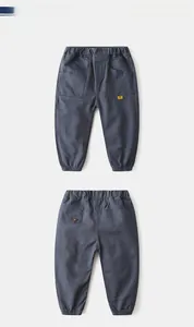 Detailed view of kids cargo pants with elastic waist, drawstring cuffs and large pockets