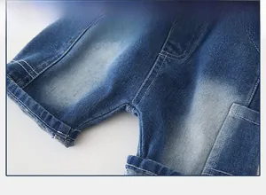 Detail of reinforced crotch stitching and washed denim fabric on boys' summer shorts