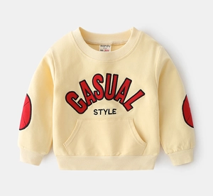 Close-up of kids yellow sweatshirt showing casual style text and red elbow patches