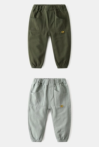 Detail of cargo pants showing elastic waistband and large pentagonal patch pockets