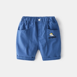 Detail of boys' blue cotton shorts featuring whale embroidery and elastic waistband