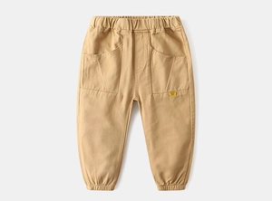 Detail of khaki kids cargo pants featuring elastic waist and large side pockets with tags