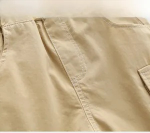 Close-up of light khaki cotton twill fabric with neat white double stitching detail