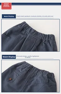 Detail of elastic waistband and rear pocket with button on boys casual trousers