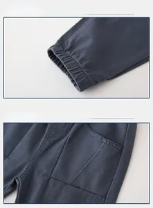 Detail view of elastic ribbed cuffs and side pocket with label on boys' casual pants