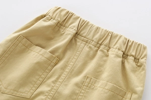 Detail of boys' khaki cotton shorts showing elastic waistband and back pocket stitching