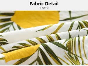 Macro view of twill weave fabric featuring yellow dots and green palm leaf prints