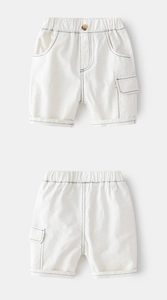 Detail of boys beige cotton cargo shorts featuring contrast stitching and wooden button