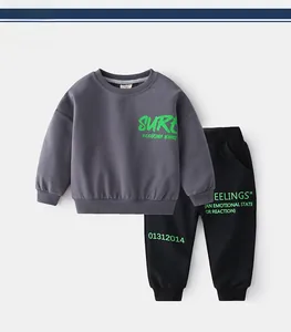 Détail du tissu en coton avec imprimé vert SURF sur l'ensemble de sport enfant