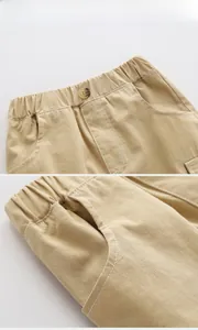 Detail view of khaki cotton boys shorts showing elastic waist and reinforced stitching