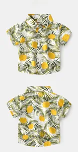 Front and back view of kids' tropical shirt featuring lemon and palm leaf prints