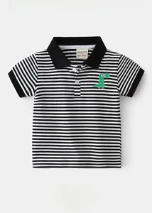 Close-up of green dinosaur embroidery on a striped cotton polo shirt for boys