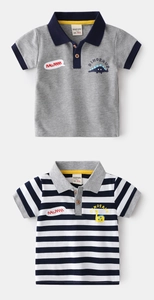 Detail of boys' polo shirts featuring dinosaur prints and textured piqué fabric