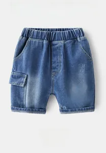Detail of blue denim shorts for boys with elastic waistband and yellow graffiti print