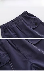 Detailed view of dark blue cargo shorts with white contrast stitching and elastic waist