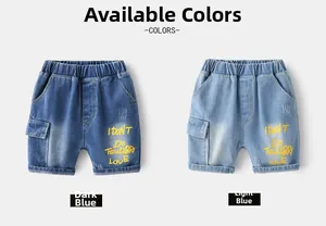 Detail of kids denim shorts showing elastic waist and yellow graphic print