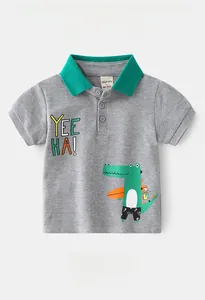 Detail view of boys polo shirt featuring Yee Ha print and surfing crocodile pattern
