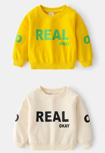 Detail showing ribbed crewneck and 'REAL OKAY' letter print on yellow and beige sweatshirts