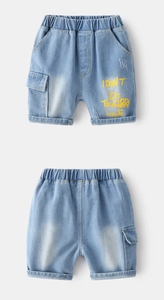 Detail of kids denim shorts with cargo pockets, distressed hem and yellow letter print