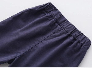 Detail of elastic waistband and neat stitching on boys navy blue cotton leisure shorts