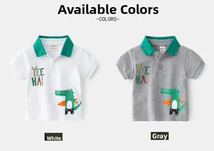 Detail of boys' cartoon polo shirts in white and grey with surf crocodile print