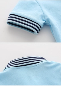 Detail view of the ribbed knit striped collar and cuffs on a blue piqué cotton polo shirt
