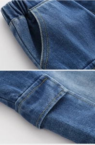 Close-up of elastic waistband and cargo pockets on blue denim shorts for boys