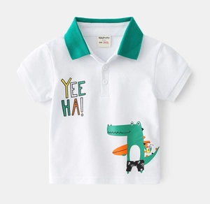 Detail of white cotton polo shirt with green collar and surfing crocodile cartoon print