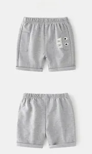 Front and back detail of grey knit shorts with elastic waist and monster eye embroidery