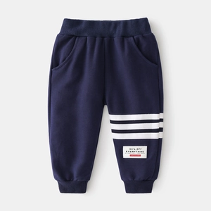 Detail view of navy blue kids joggers featuring white side stripes and ribbed cuffs