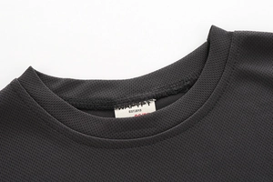 Macro shot of breathable mesh fabric and detailed neckline stitching on dark grey sports T-shirt