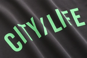 Detailed macro view of breathable mesh fabric with vibrant neon green City Life text