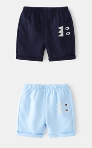 Detailed close-up of boy's cotton shorts with cute cartoon monster eye patch design