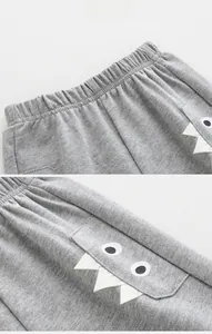 Detail of kids shorts with elastic waistband and cartoon monster pocket design